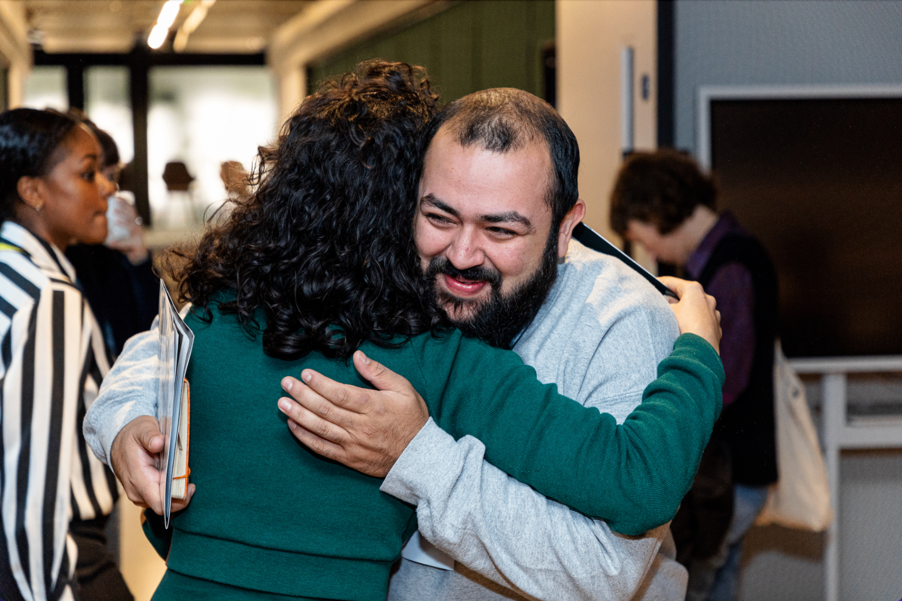 Two members embracing at a TRIUMPH gathering